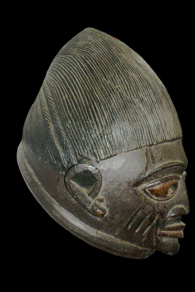 A mask from Nigeria, possibly Igbo, photographed by Remo Kurka in the National Museum of Ghana in Accra around 2007, prepared as an indexed-colour GIF on a black background